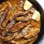 Pan-seared steak in butter sauce sizzling in cast-iron skillet