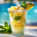 Pineapple Coconut Mojito Mocktail garnished with mint and lime