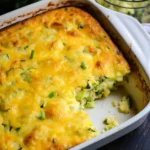 Baked zucchini cornbread casserole with golden crust in baking dish