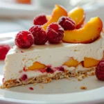 No-bake peach raspberry cheesecake slice with fresh fruit topping